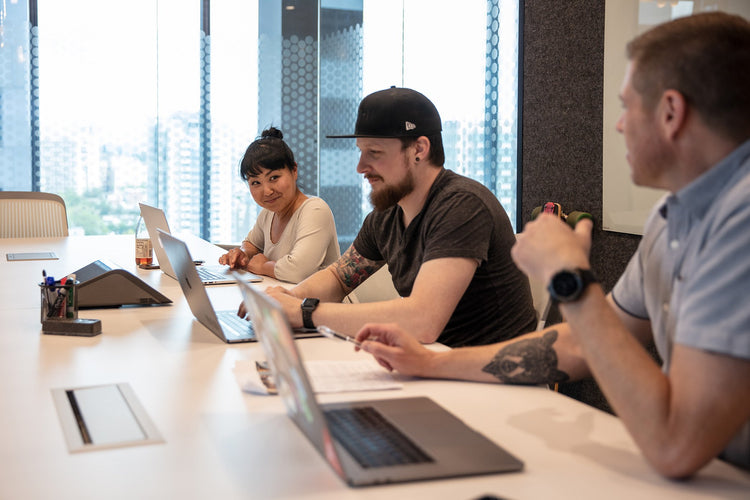 Three workers on their laptop computers